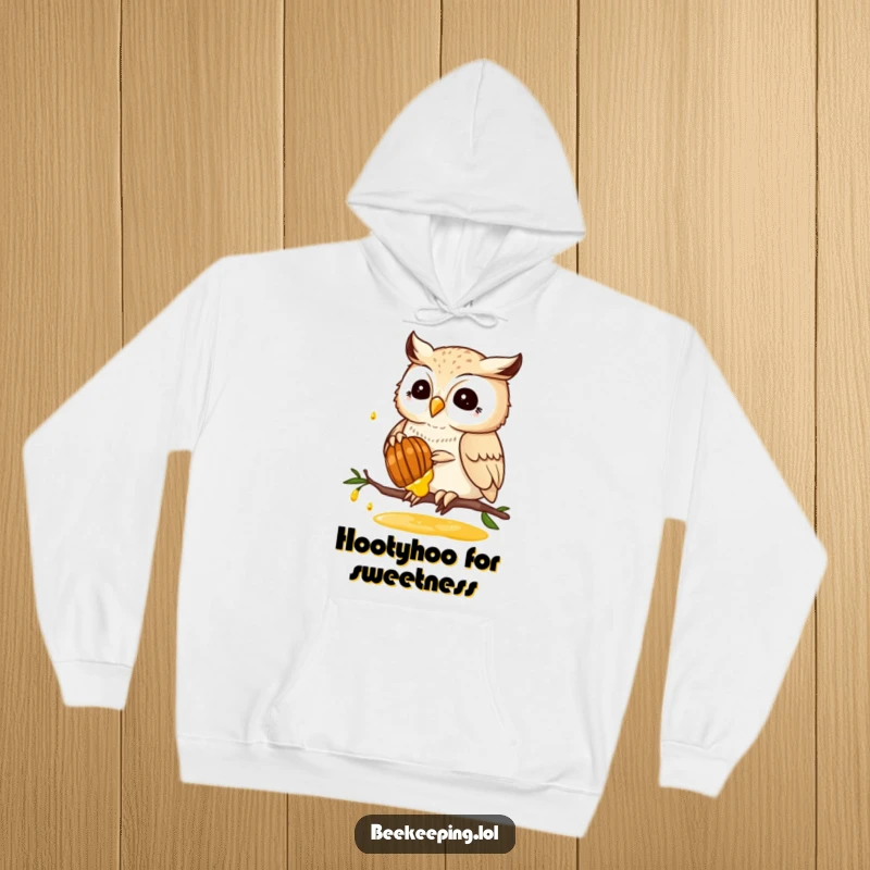 Funny hoodie with a proud owl gently harvesting honey from a honeycomb, a cozy and humorous depiction of nature's bounty.