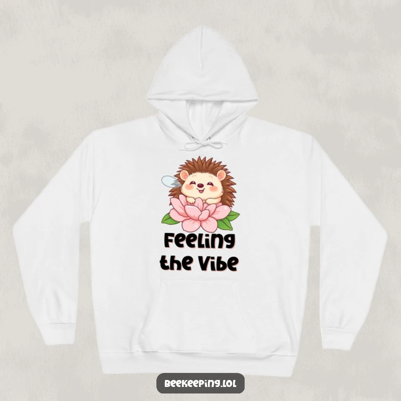 Funny giggling hedgehog buzzing around a flower on a cozy hoodie, perfect for humorous warmth.