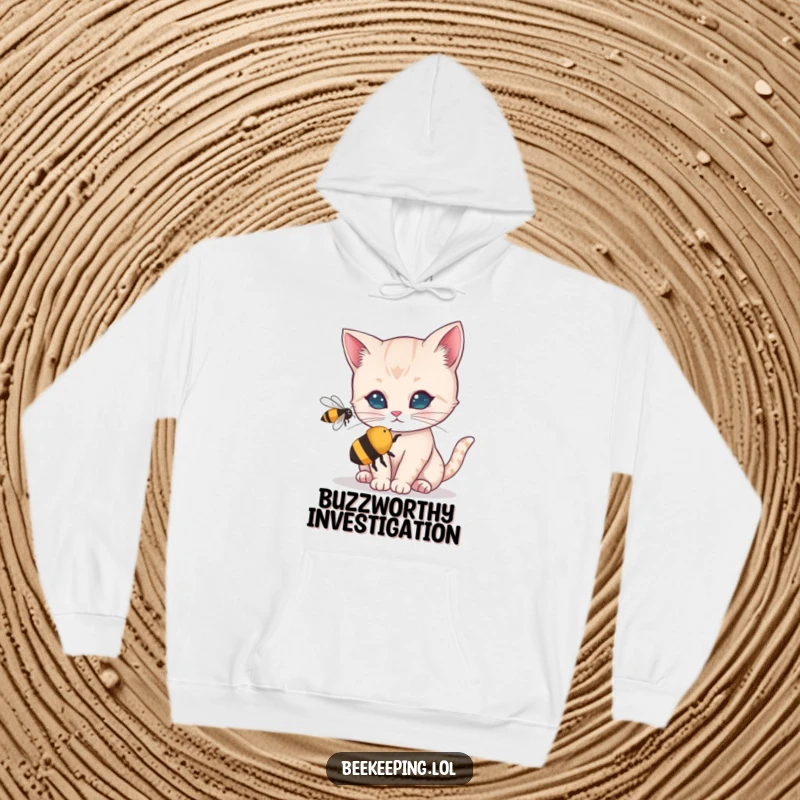 Funny hoodie showcasing a wide-eyed cat intensely observing a small buzzing bee. A humorous and cozy garment for animal lovers.