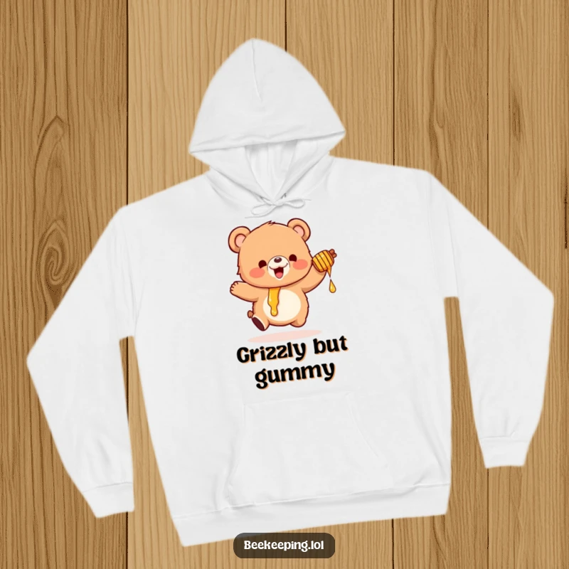 Funny hoodie showcasing a small, fluffy bear bouncing with excitement, holding a dripping honey pot, a symbol of sweet joy.
