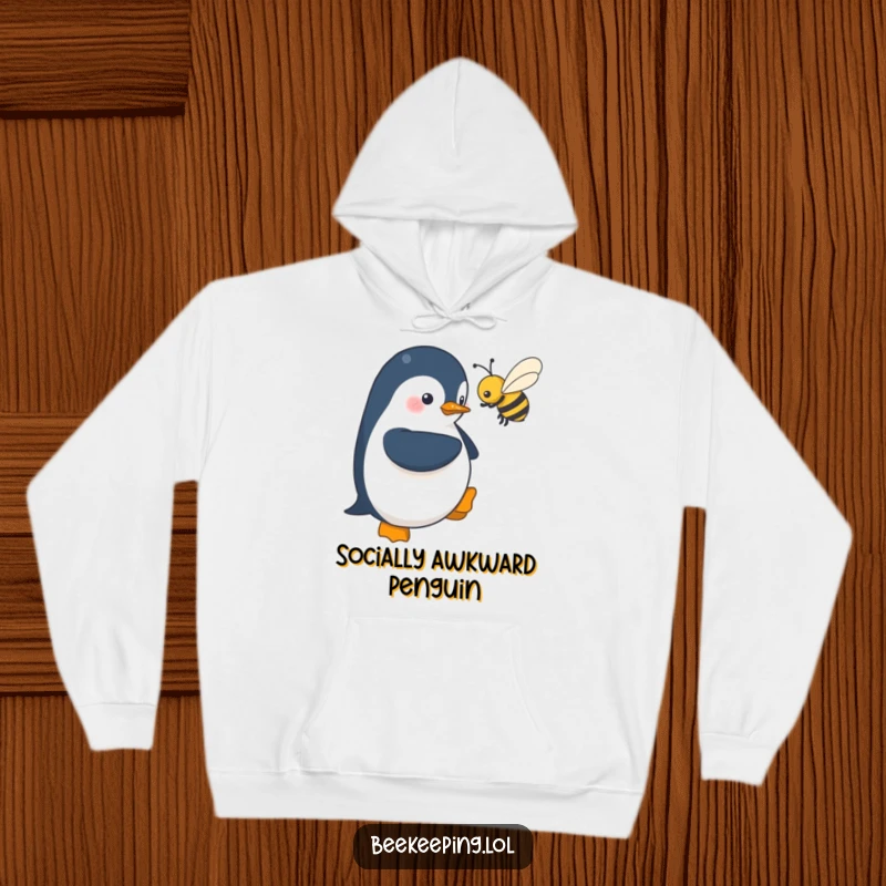 Funny hoodie print: a shy penguin stands near a buzzing bee, designed with adorable charm and a humorous portrayal of quiet courage.