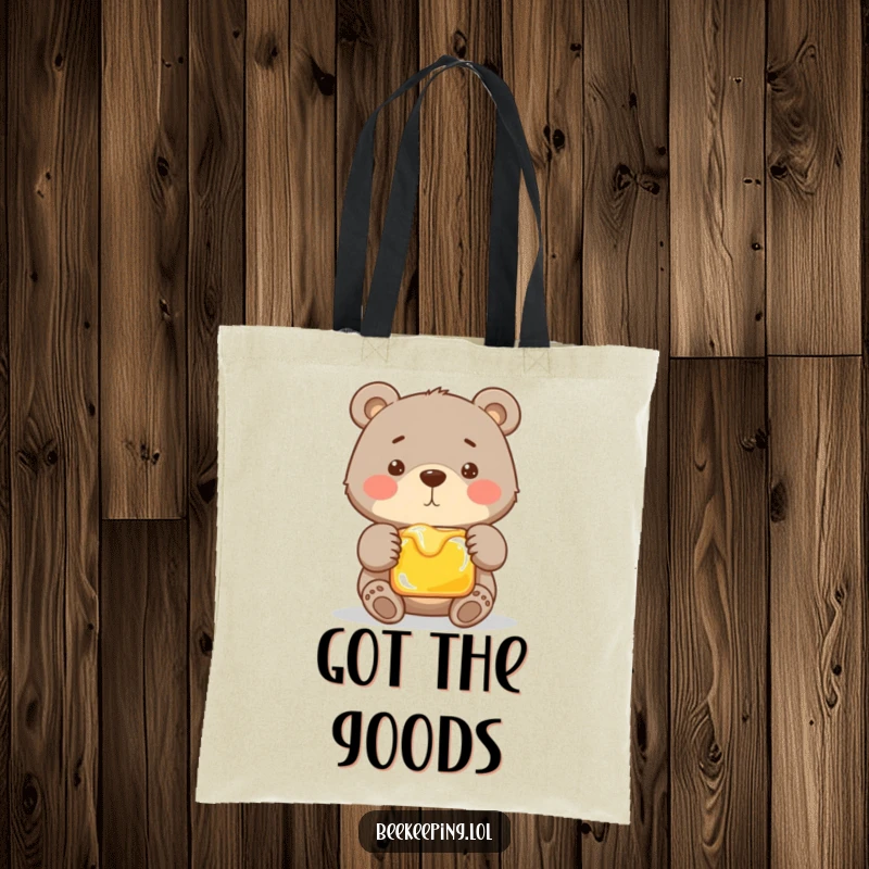 Funny tote bag featuring a proud bear gently handling a frame of honey. A humorous and practical accessory for daily errands.